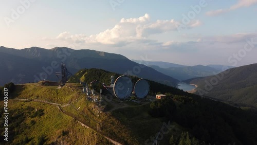 Aerial view of the big parabolic antenna of the radio station abandoned on the top of Monte Giogo, used during cold war. Comano, Massa and Carrara province, Lagastrello lake, Tuscany, Italy.  photo