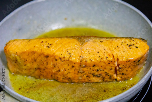 Salmon fish grilled in butter and olive oil
