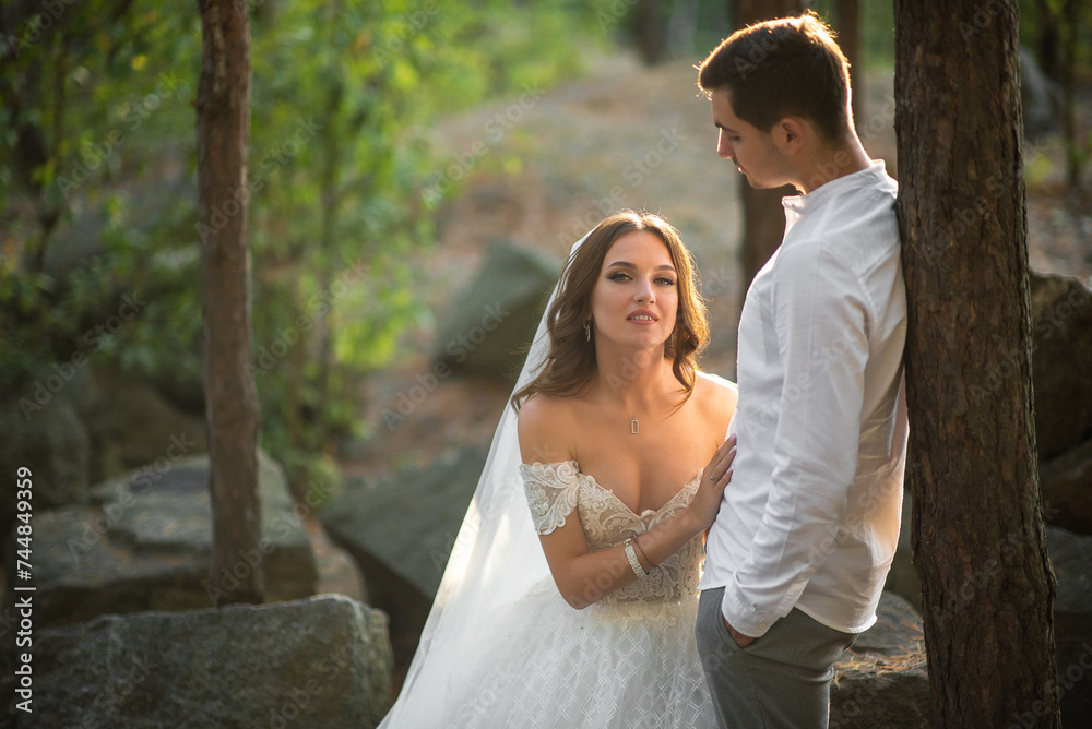 Sunlight fills the forest as newlyweds share joyful embraces Sunlight fills the forest as newlyweds share joyful embraces