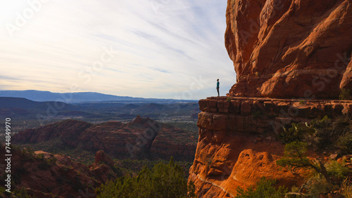 Hiker on cliff edge of Cathedral Rock in Sedona, Arizona USA photo