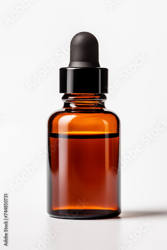 A brown bottle of aromatherapy essential oil with black cap on white background