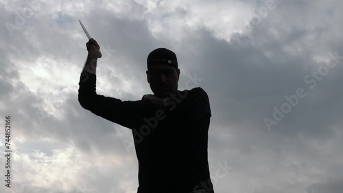 A man performing knife attack aggression: video of a killer or maniac with knife. Martial art Kali Arnis Escrima 