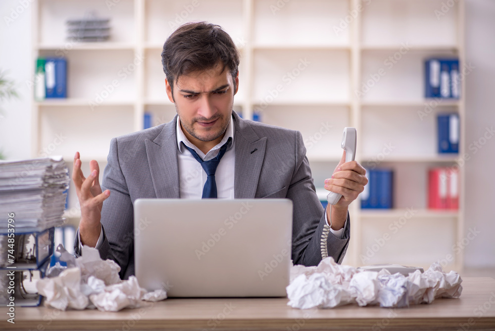 Young male employee in brainstorming concept Young male employee in brainstorming concept