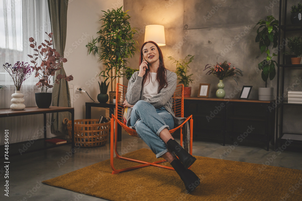 Obraz premium one young woman at home use mobile phone smartphone have a call talk