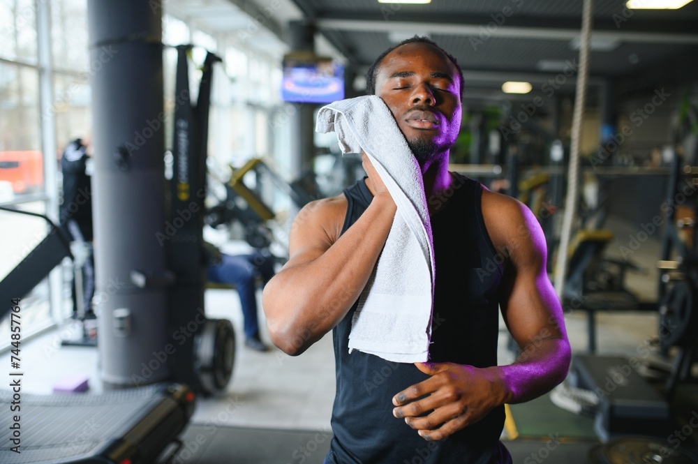 Thoughtful young man with towel in health club Thoughtful young man with towel in health club