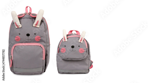 Front view closeup of colorful bunny-shaped schoolbags isolated on white copy-space background. (ID: 744857782)