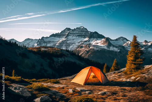 A tent pitched in a serene mountain landscape during the golden hour, with warm light bathing the scene. © EricMiguel