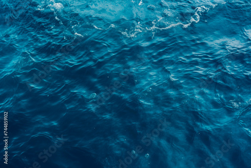 Calm blue ocean surface with gentle waves, depicting serenity and depth.