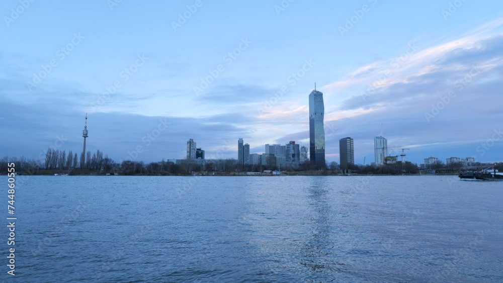 Cargo Ship at Danube River and City Waterfront Skyline near Reichsbruecke seen from Handelskai in Vienna Cargo Ship at Danube River and City Waterfront Skyline near Reichsbruecke seen from Handelskai in Vienna