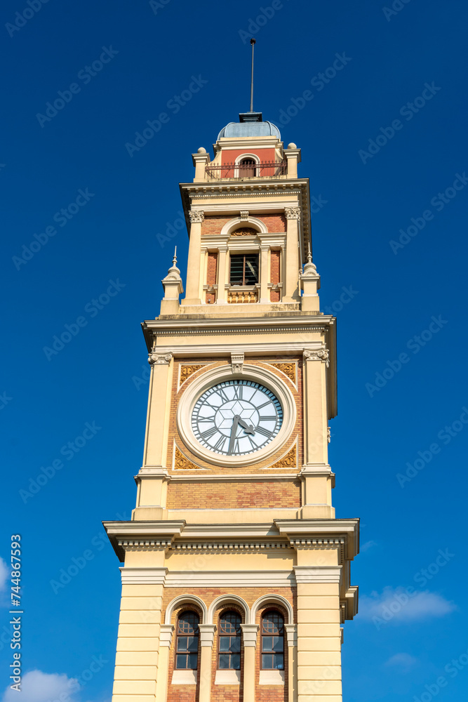 The traditional clock in the Luz station tower, on the terrace of the building that houses the Portuguese language museum, in the city of São Paulo