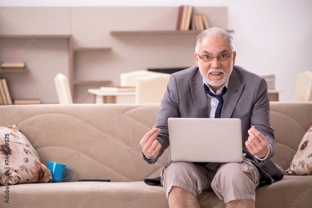 Old male employee working from home during pandemic Old male employee working from home during pandemic