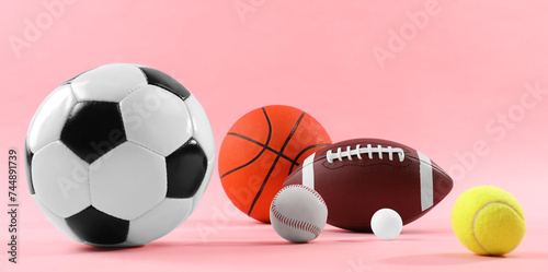 Many different sports balls on pink background. Banner design