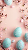 Colorful easter eggs and spring flowers on pastel pink background