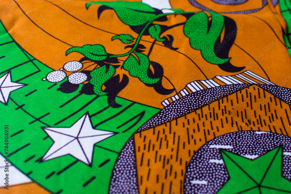 top view of orange ankara fabric, flatlay of nigerian wax cloth with designs, spread out orange ankara material