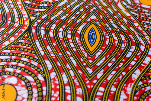 top view of orange ankara fabric, flatlay of nigerian wax cloth with designs, spread out orange ankara material photo