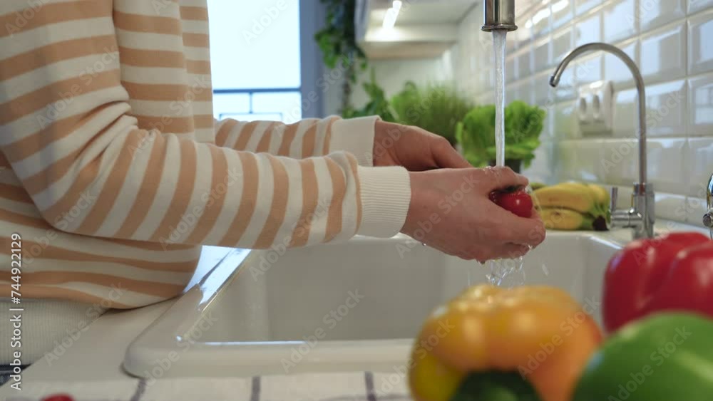 Woman hands washing cherry tomatoes under tap water. Healthy organic tasty fresh vegetables full of vitamins, used for salad cooking. Food for detox, dieting, energy Woman hands washing cherry tomatoes under tap water. Healthy organic tasty fresh vegetables full of vitamins, used for salad cooking. Food for detox, dieting, energy