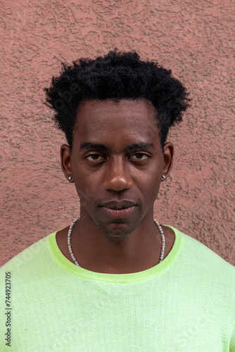 Portrait of a Person in Neon Green Shirt, Face Obscured, Against Textured Pink Wall - Ideal for Concepts of Anonymity and Privacy