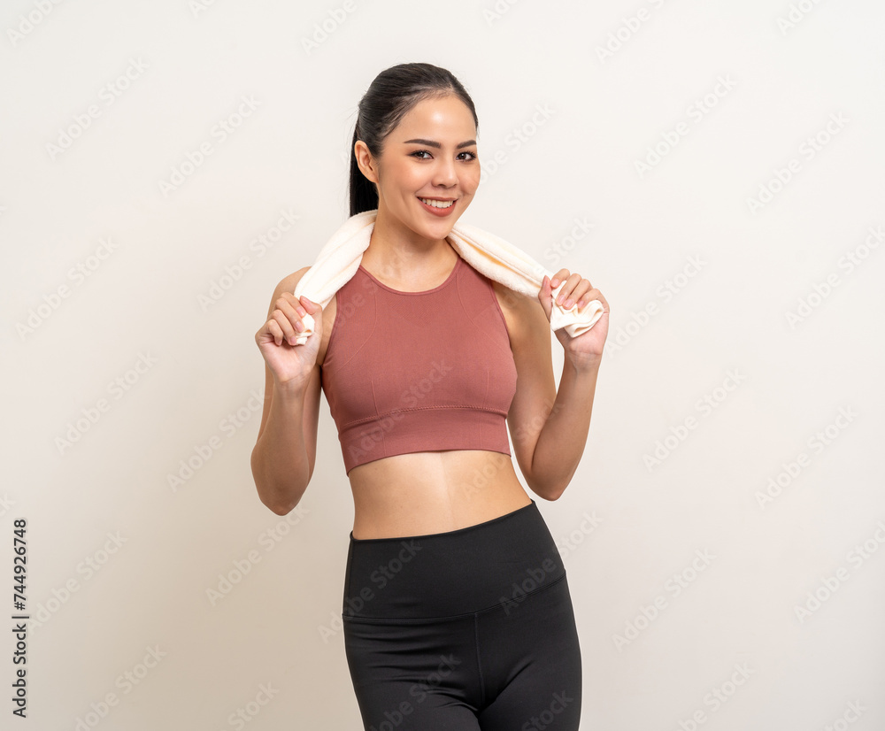 Young beautiful smiling asian woman in sportswear with towel on isolated background. Portrait happy healthy slim fit and firm latin attractive sporty woman standing pose exercise workout in studio. Young beautiful smiling asian woman in sportswear with towel on isolated background. Portrait happy healthy slim fit and firm latin attractive sporty woman standing pose exercise workout in studio.