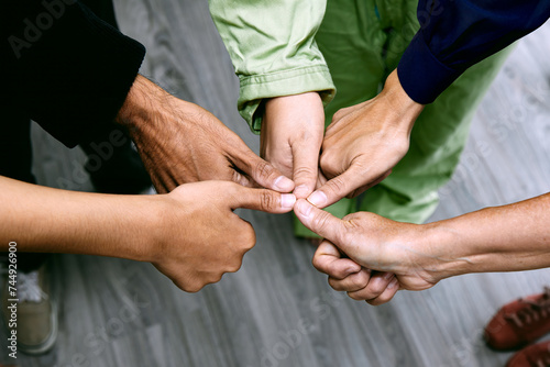 A collaborative standing team giving thumbs up with circle shape close up