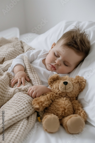 Adorable newborn sleeping on white bed with plush toy, copy space for text