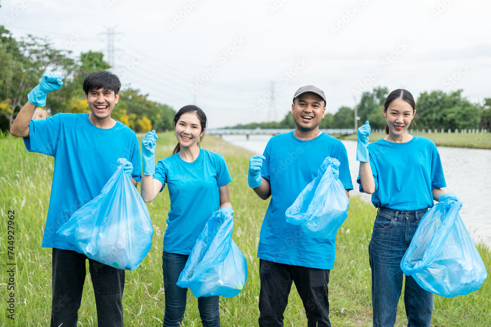 Happy volunteer people group charity with garbage bags cleaning up in park. Corporate social responsibility and society activity for Environment . Ecology and CSR concept. Happy volunteer people group charity with garbage bags cleaning up in park. Corporate social responsibility and society activity for Environment . Ecology and CSR concept.