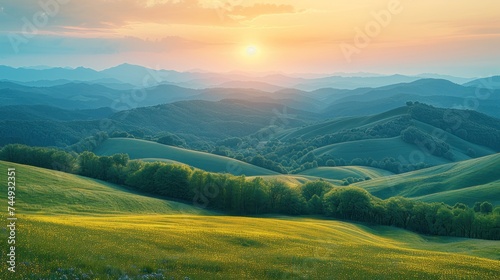 mountainous countryside at sunset. landscape with grassy rural fields and trees on hills rolling in to the distance in evening light. photo