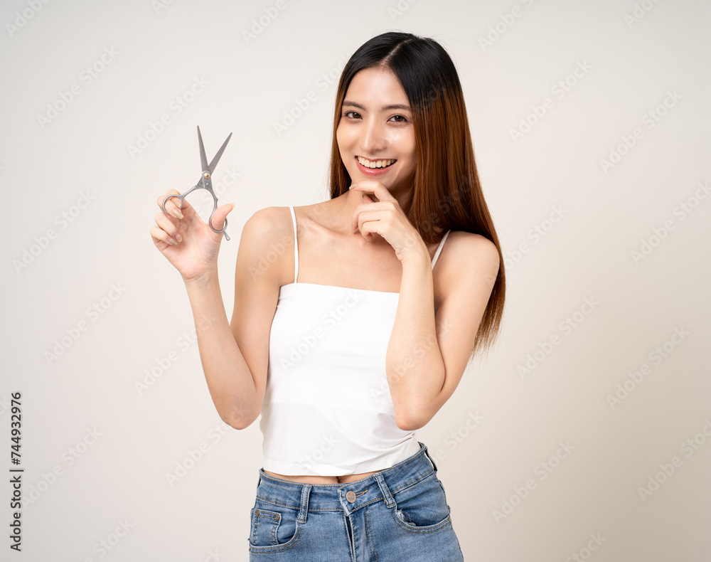 A beautiful woman with long hair is thinking about what style she should cut her hair with scissors or going to a beauty salon. A beautiful woman with long hair is thinking about what style she should cut her hair with scissors or going to a beauty salon.