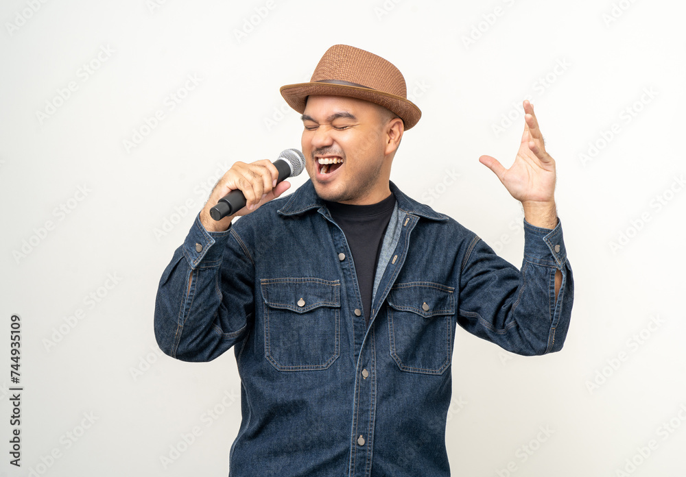 Happiness young asian man singing song. Artist vocalist singer on isolated background. Confident man public speaking talking with microphone in studio. Happiness young asian man singing song. Artist vocalist singer on isolated background. Confident man public speaking talking with microphone in studio.
