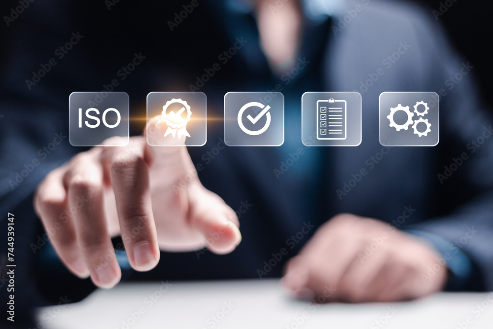 ISO Certification and standardization process concept. Certificate, Approval, Compliance to requirements. Businessman touching quality assurance icon for international standards. ISO Certification and standardization process concept. Certificate, Approval, Compliance to requirements. Businessman touching quality assurance icon for international standards.