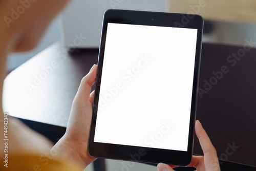 Hand holding digital tablet mockup of blank screen. Take your screen to put on advertising.