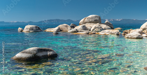 North Shore of Lake Tahoe Secret Harbor with giant granite boulders in clear blue turquoise water on a bright sunny day 