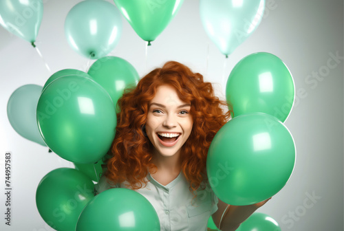 Laughing girl with green balloons. Birthday and celebration concept. © ulkas