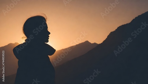 A warm silhouette of a person in the mountains
