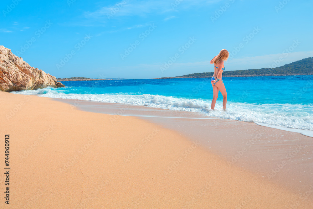 Blonde Girl on tropical beach - Beautiful woman in bikini enjoy a swim in the crystal clear water - Kaputas, Antalya Blonde Girl on tropical beach - Beautiful woman in bikini enjoy a swim in the crystal clear water - Kaputas, Antalya