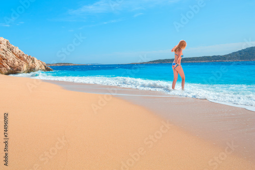 Fototapeta Naklejka Na Ścianę i Meble -  Blonde Girl on tropical beach - Beautiful woman in bikini enjoy a swim in the crystal clear water - Kaputas, Antalya