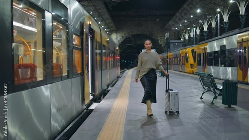 Traveller going out wagon railway carrying luggage. Short hair woman walking