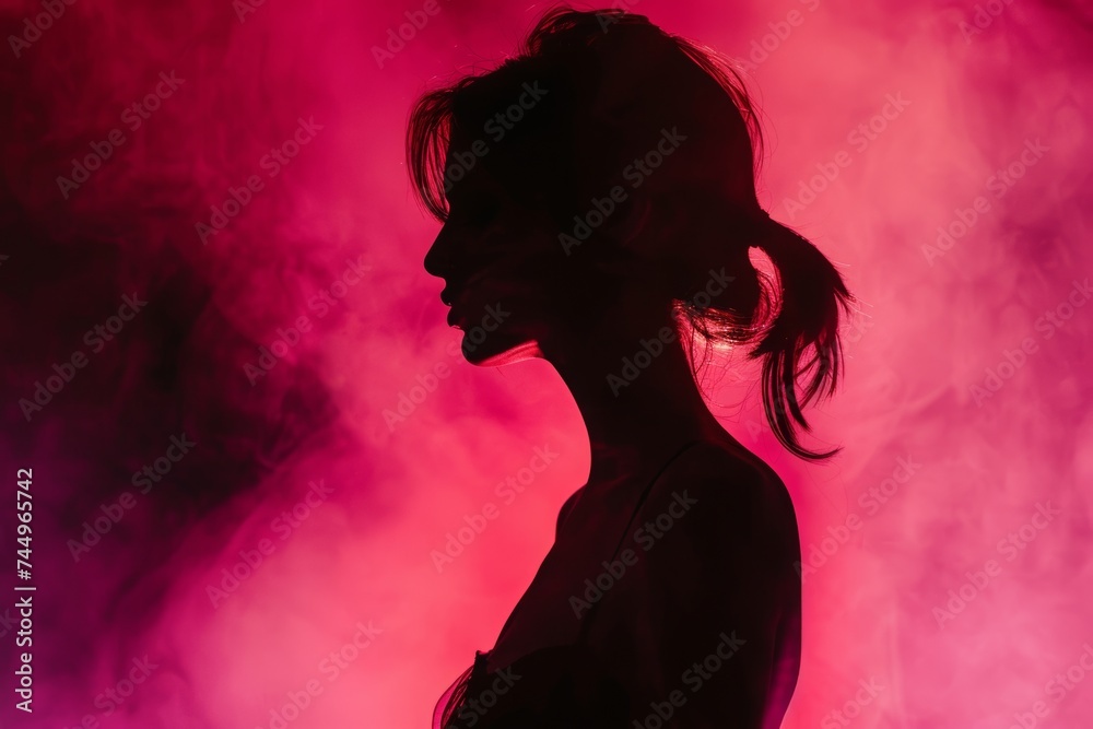 Mystery in Magenta: A silhouetted profile of a woman against a vibrant magenta backdrop, evoking intrigue and sensuality.
Mystery in Magenta: A silhouetted profile of a woman against a vibrant magenta backdrop, evoking intrigue and sensuality.