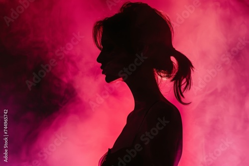 Mystery in Magenta: A silhouetted profile of a woman against a vibrant magenta backdrop, evoking intrigue and sensuality.