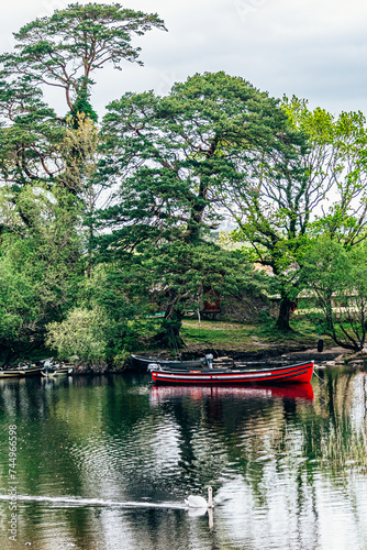 Moored boats on river in Killarney National Park, Ireland. High quality photo