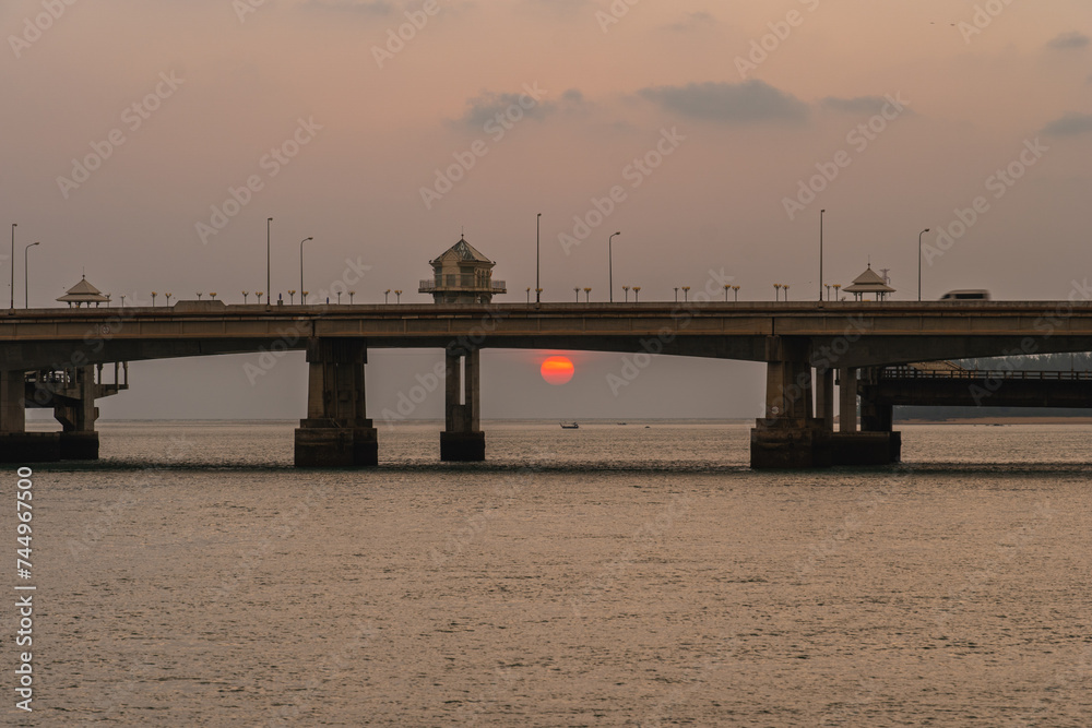 scenery The red sun down to the behind Sarasin bridge Phuket..Scene of Colorful romantic red sunset with the bridge in sunset background..Bridge connecting the outside world to Phuket Island.