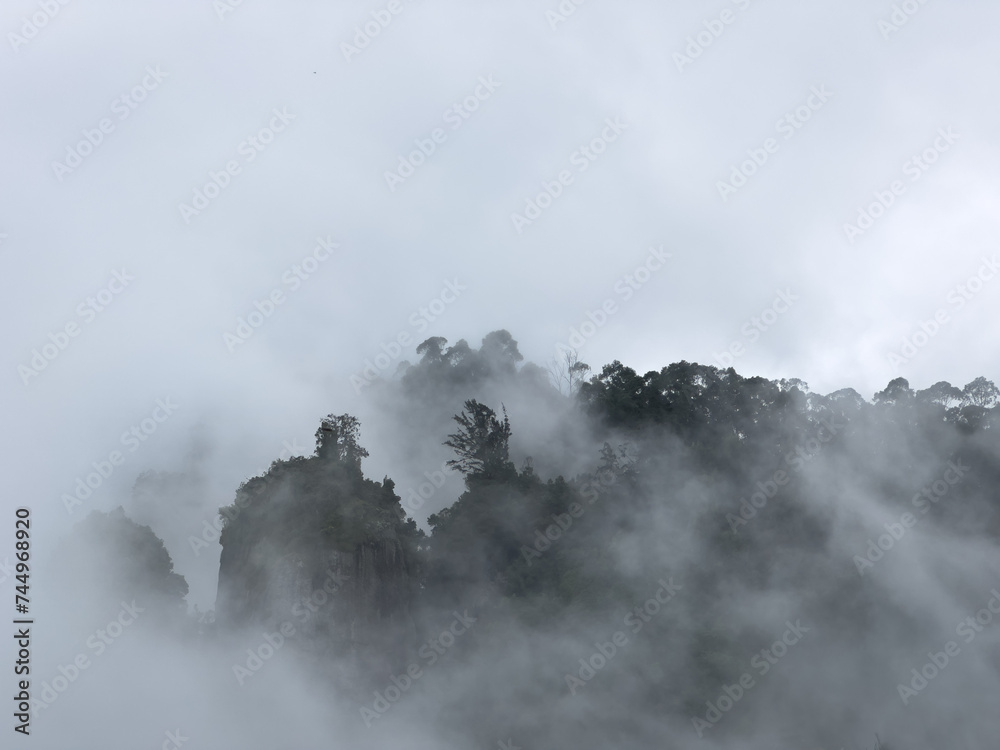 Fog covering the 3 vertical rocks known as Pillar rocks, Kodaikanal, Tamil Nadu