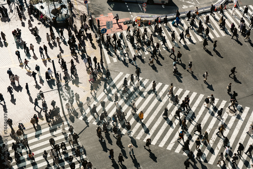People crossing the road at Shibuya crossing in Japan