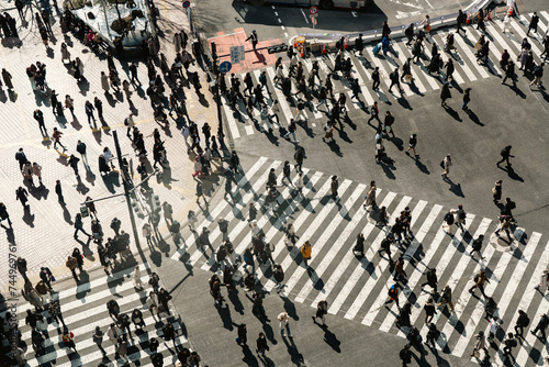 People crossing the road at Shibuya crossing in Japan photo