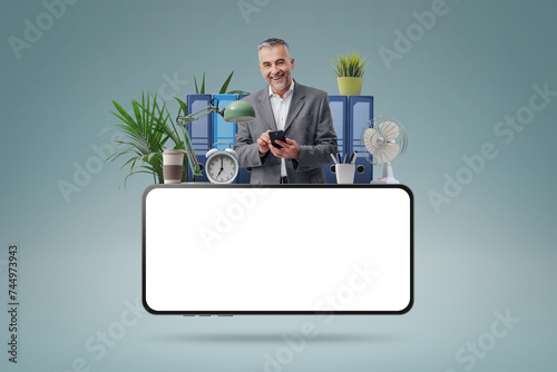 Smiling businessman and blank smartphone