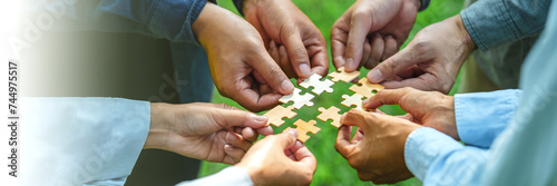 World environment day and ESG Concept of teamwork and partnership Hands join Jigsaw puzzle pieces with global community sustainable Save Earth. the Environment World Earth Day concept