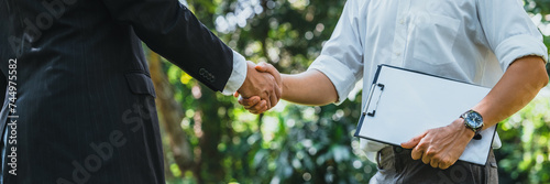 .World Environment Day business partner colleagues shaking hands during a meeting working together in sustainability. Save Earth, World Environment Day concept, Earth Day.