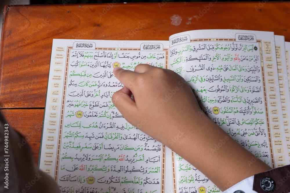 Naklejka premium Boys read Quran Kareem in the mosque, with the theme of fasting