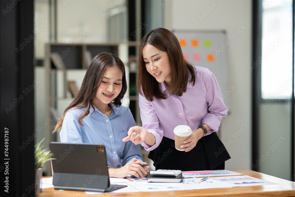 Asian business woman working and talking at the office
Asian business woman working and talking at the office