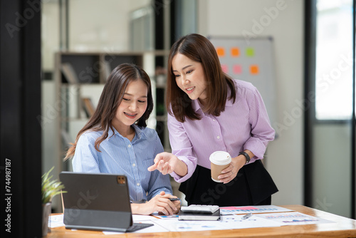 Asian business woman working and talking at the office
