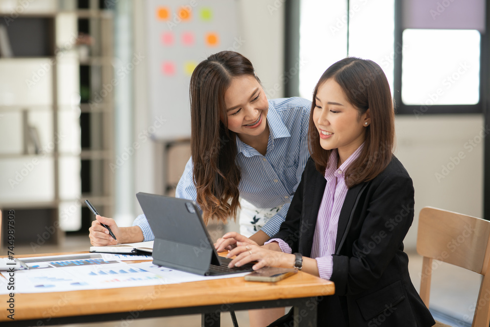 Asian business woman working and talking at the office
Asian business woman working and talking at the office